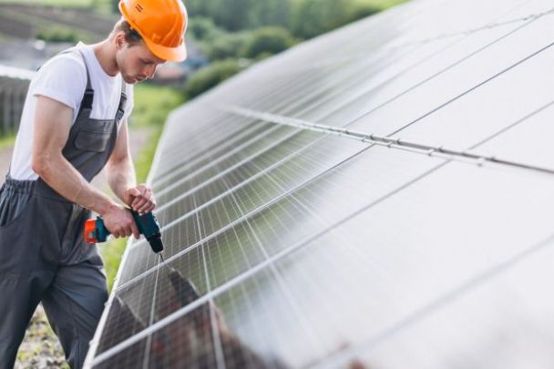 man-worker-firld-by-solar-panels